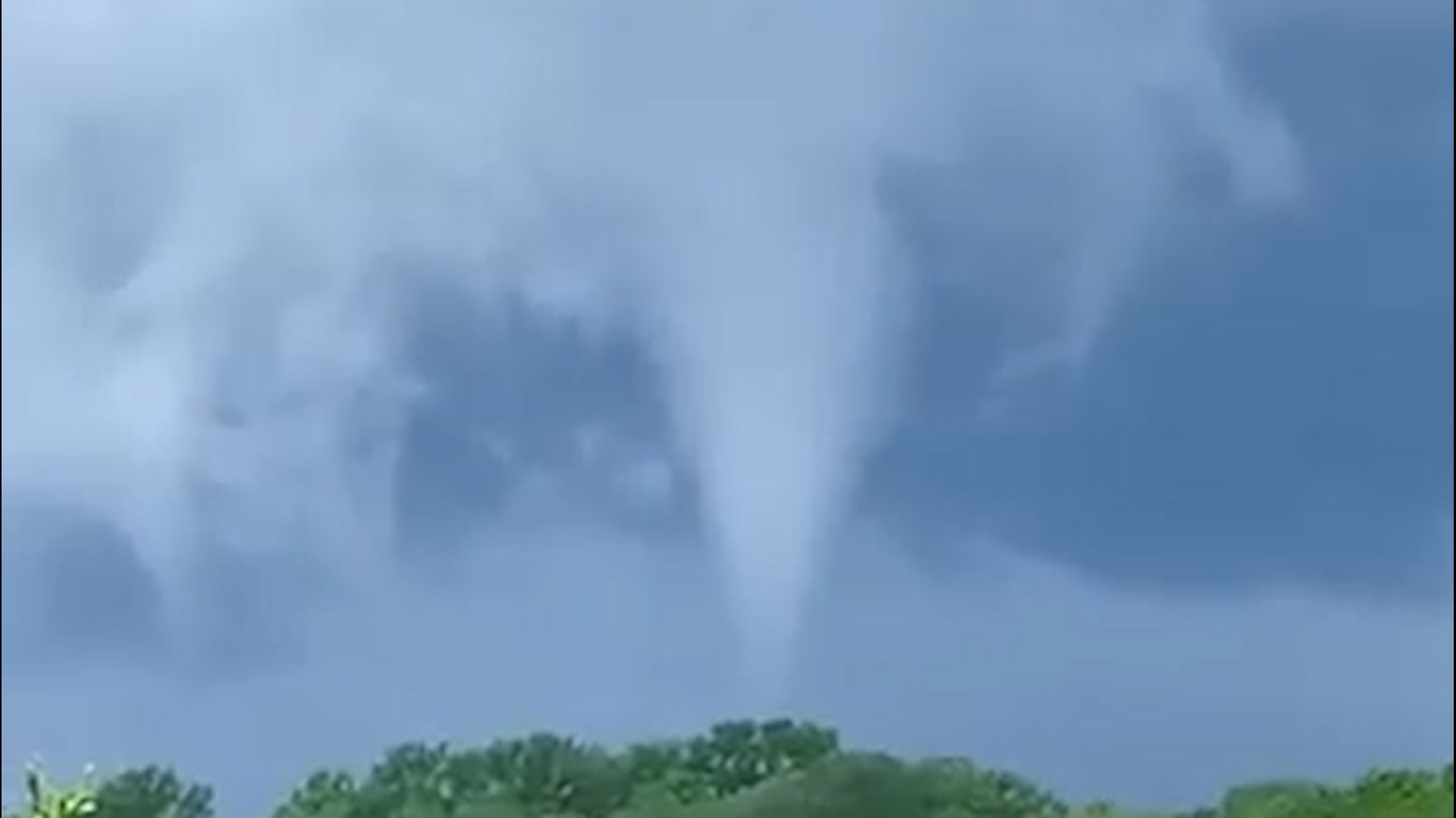 A confirmed tornado was filmed swirling from a distance by a spectator in Waukee, Iowa, on May 26.