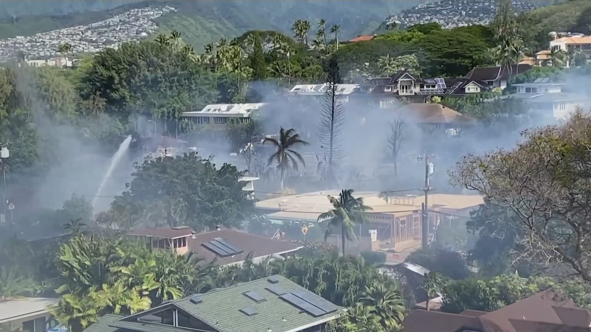 Witnesses describe the scene in Honolulu on Sunday as police respond to a shooting in which two officers died and a house fire spread.