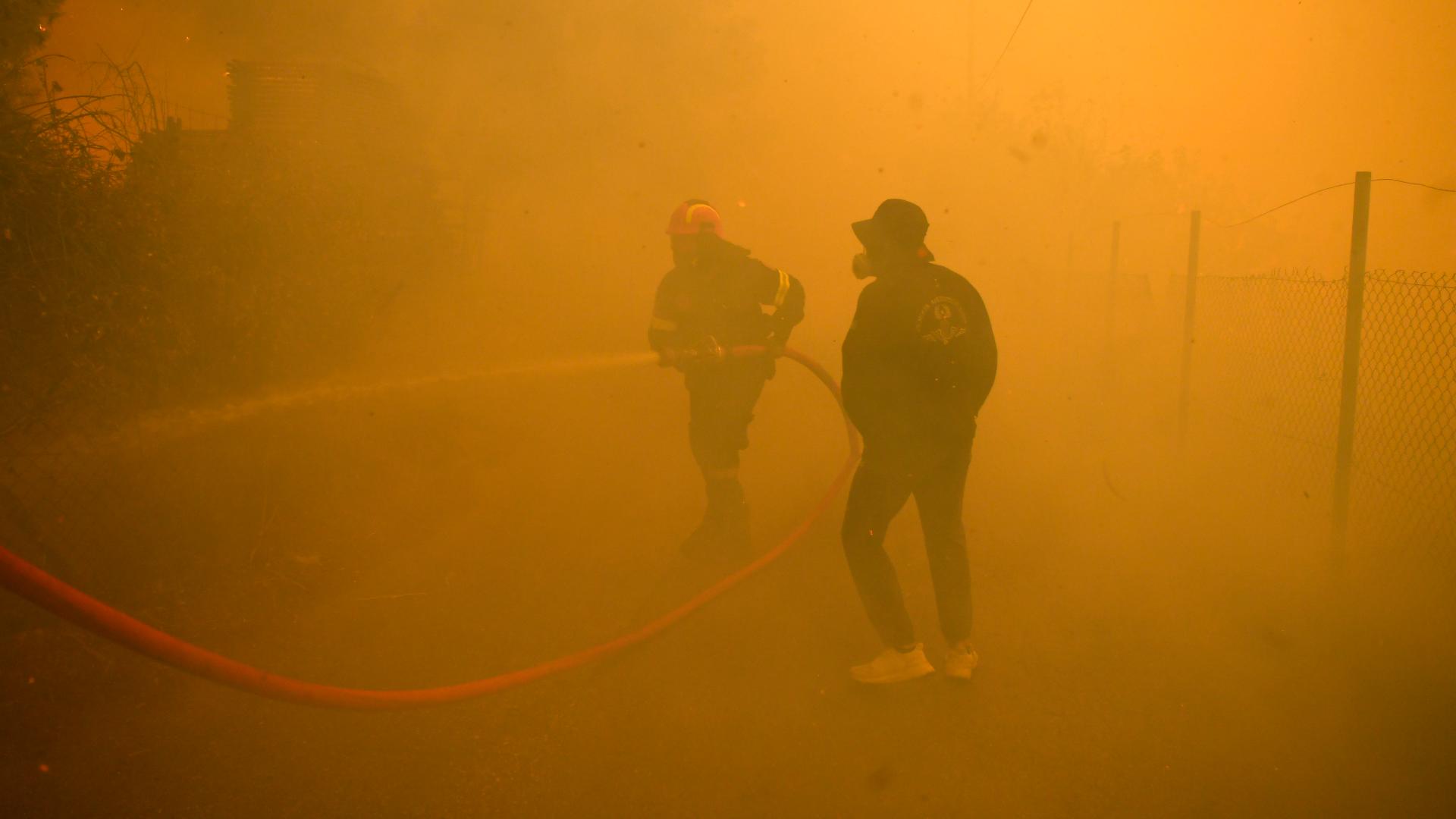 Hundreds of firefighters backed by more than two dozen water-dropping planes were battling a major forest fire raging out of control near Greece's capital.