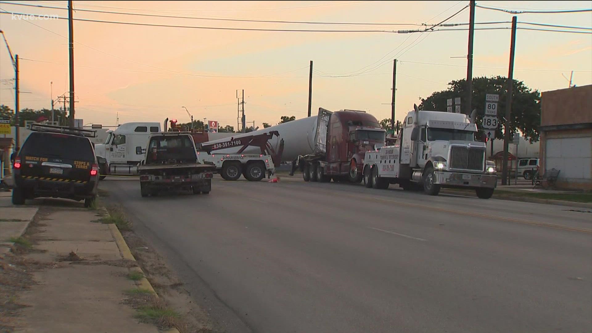 An 18-wheeler pulling what seems to be a wind turbine blade rolled over after being struck by a train in Luling on Sunday.