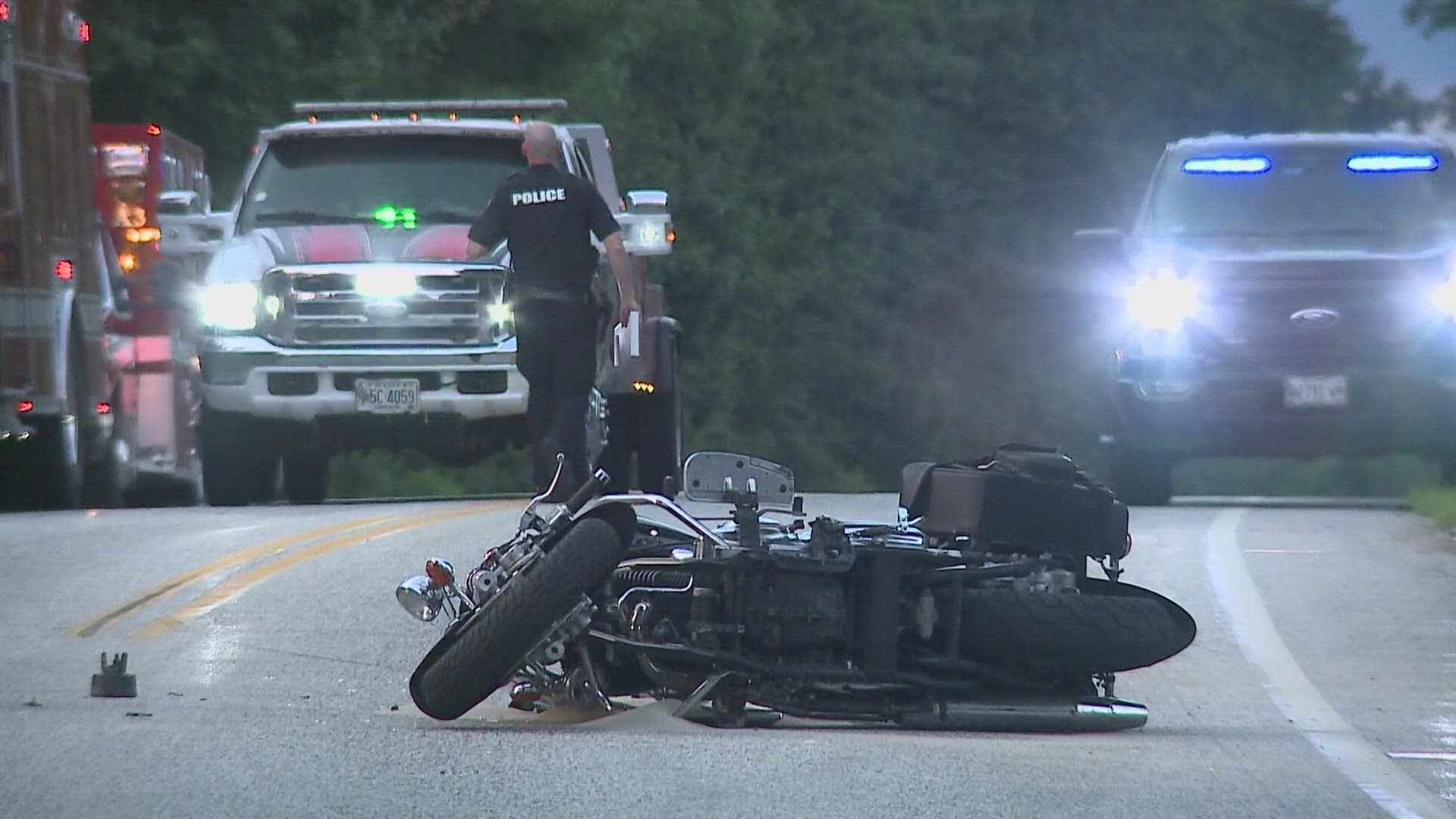 Police said the motorcyclist tried to pass a turning car when he crashed into a third vehicle.