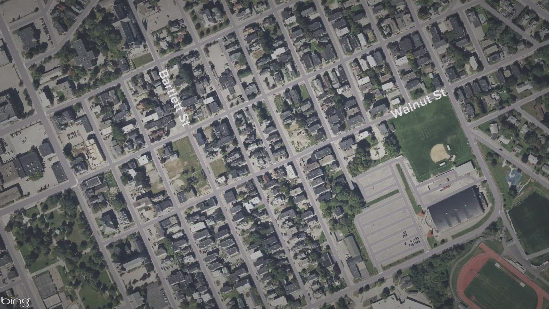 When officers arrived at the scene, they found the alleged victim hiding in a nearby apartment, suffering from two gunshot wounds, according to police.