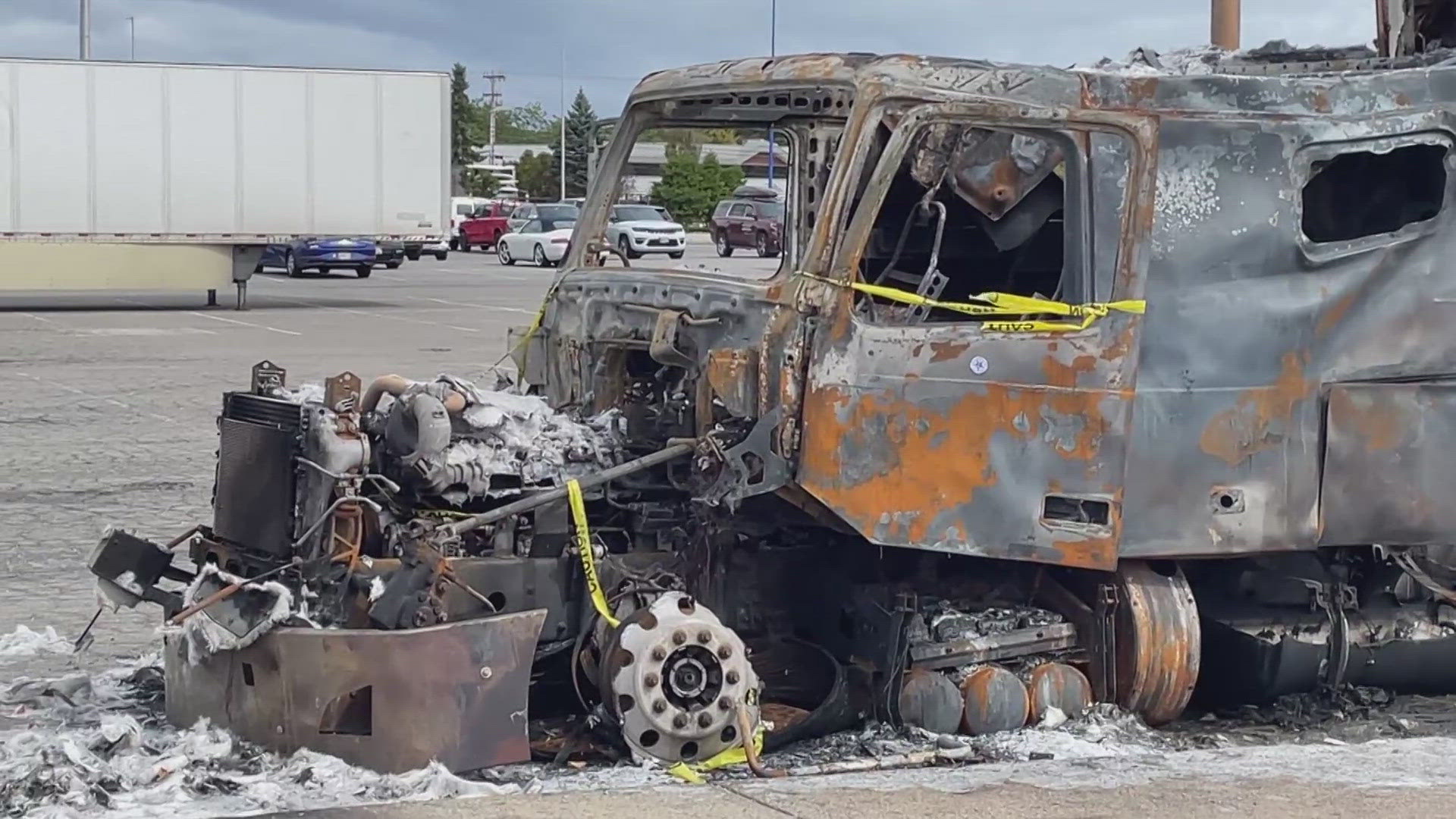 Burned tractor trailer truck still sits in parking lot 