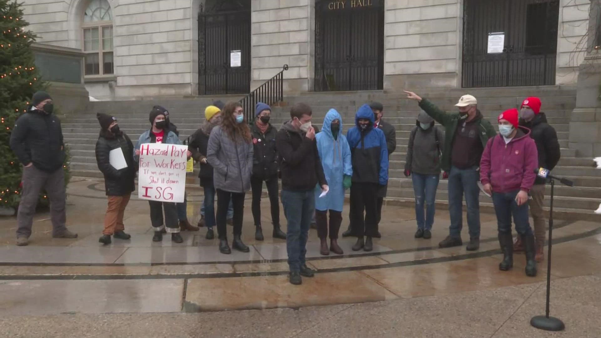 Roughly two dozen rallied at Portland City Hall, urging the City Council to keep the City's State of Emergency, which triggered hazard pay of $19.50 minimum wage
