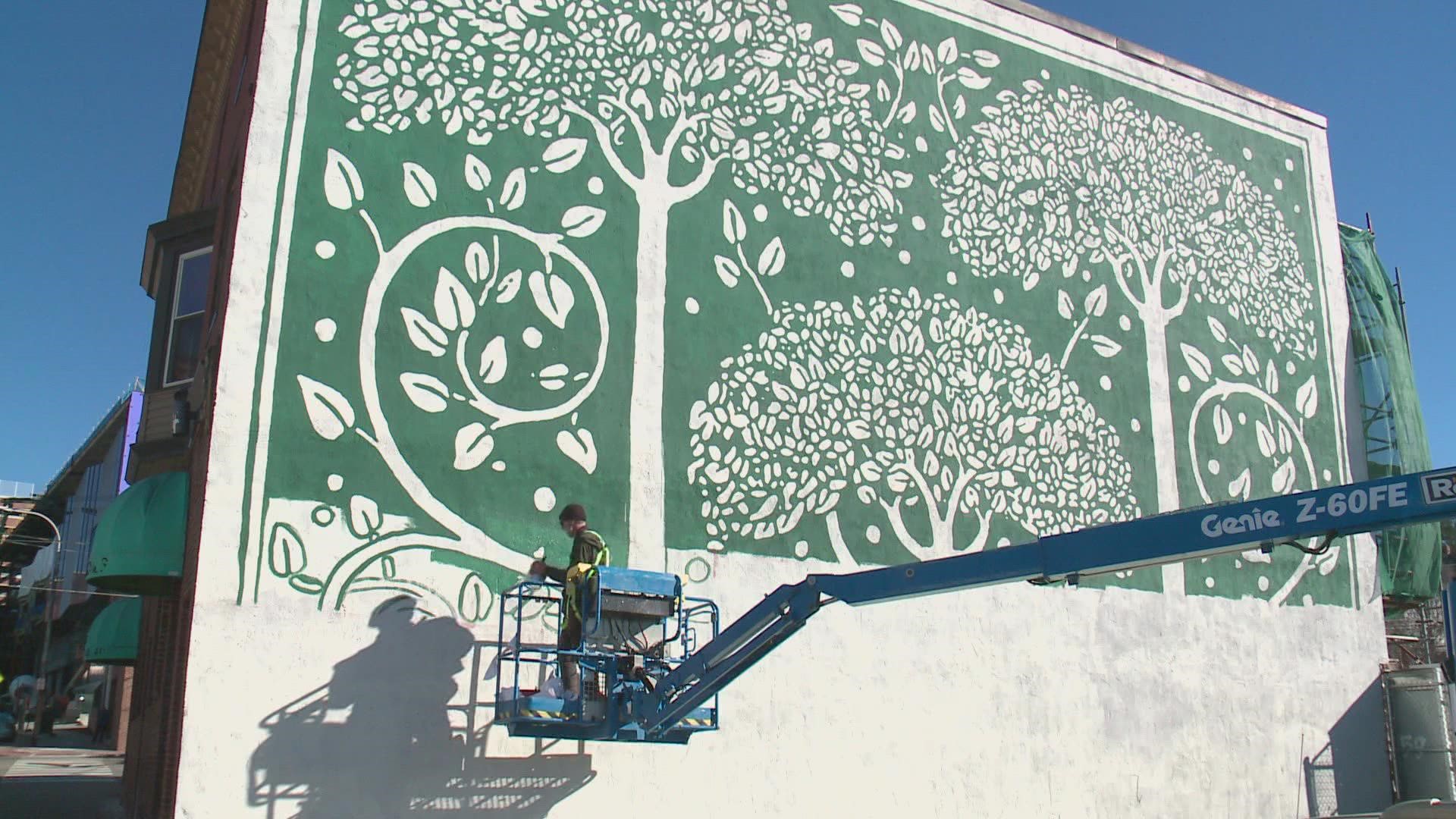 Portland artist Pat Corrigan was hired to paint the new mural, based on a British 19th century book cover.