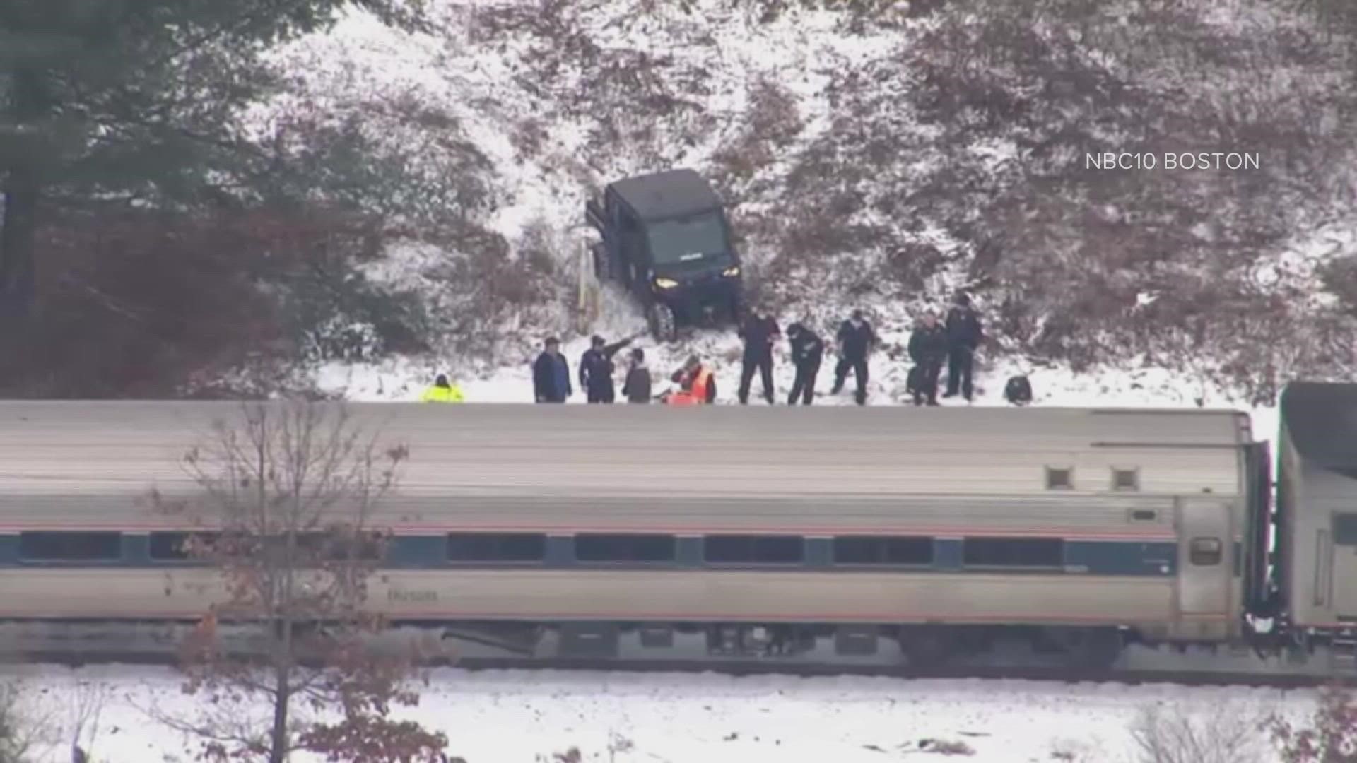 The vehicle was flipped over against a tree near the tracks and a road crossing, according to NEWS CENTER Maine's media partners at NECN.