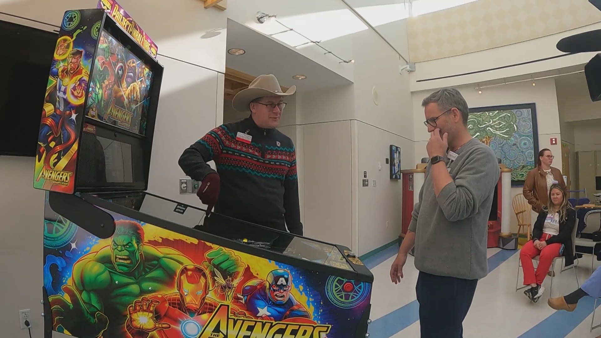 The superhero-themed pinball machine was donated to the hospital on Monday.