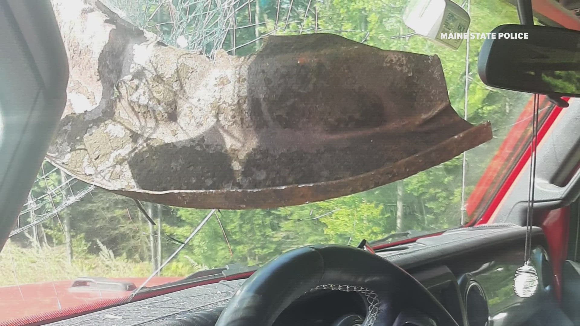 The sharp debris lodged itself into the windshield of the Jeep and came to rest just inches from her face.