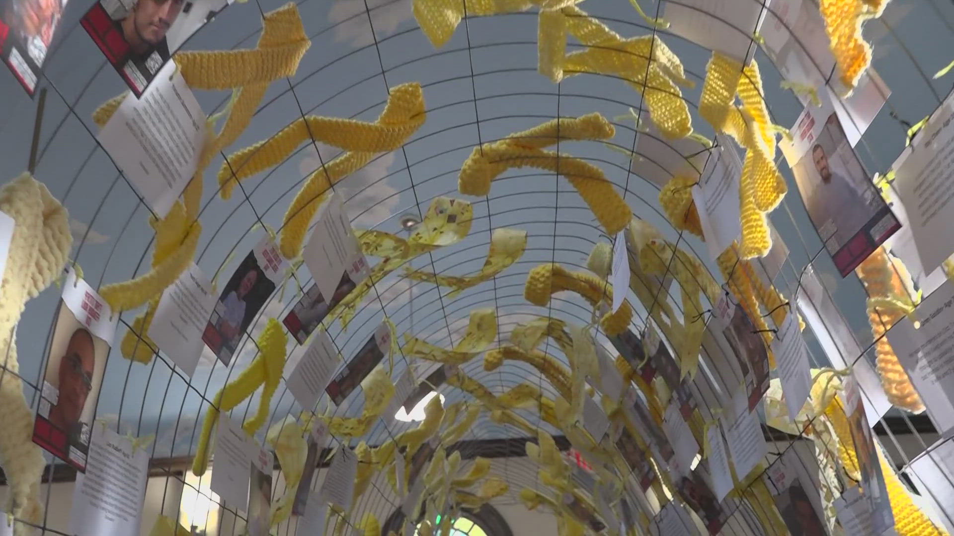 The art installation consists of 116 yellow ribbons created by a local mother and daughter, each one representing a hostage still in captivity.