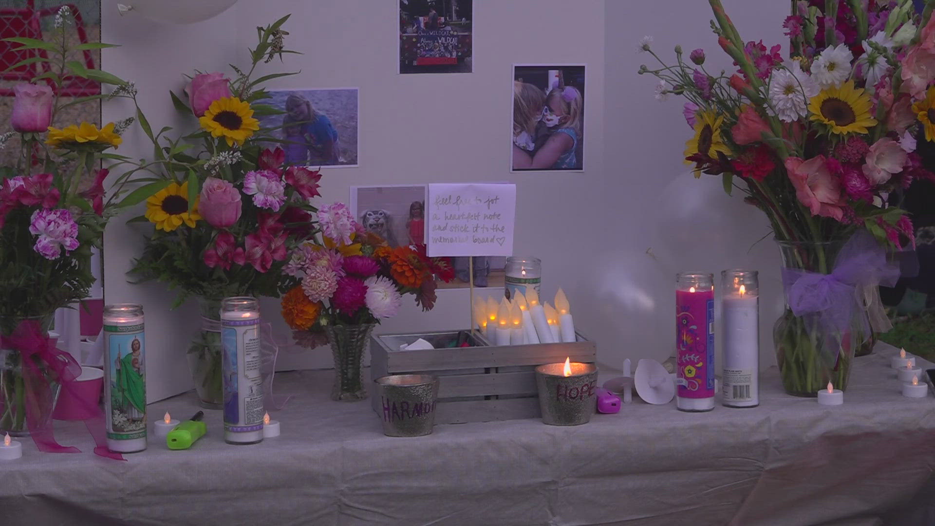 Hundreds of community members attended a candlelight vigil outside the school where Harmony and Hope West were enrolled.