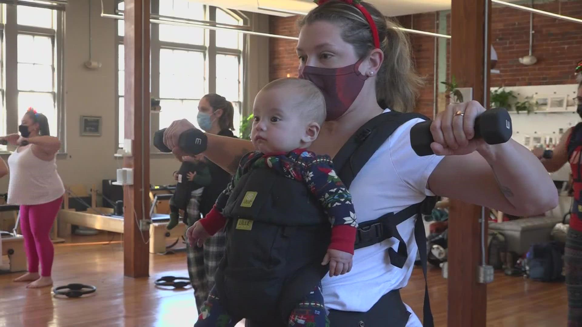 The class allows new moms to work out together with their little ones strapped right in front of them.