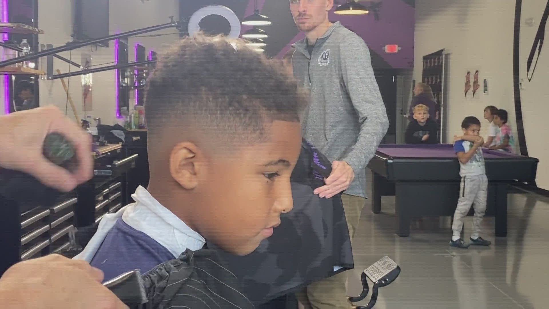 Nealy 150 kids got free haircuts in Auburn Monday before starting school.