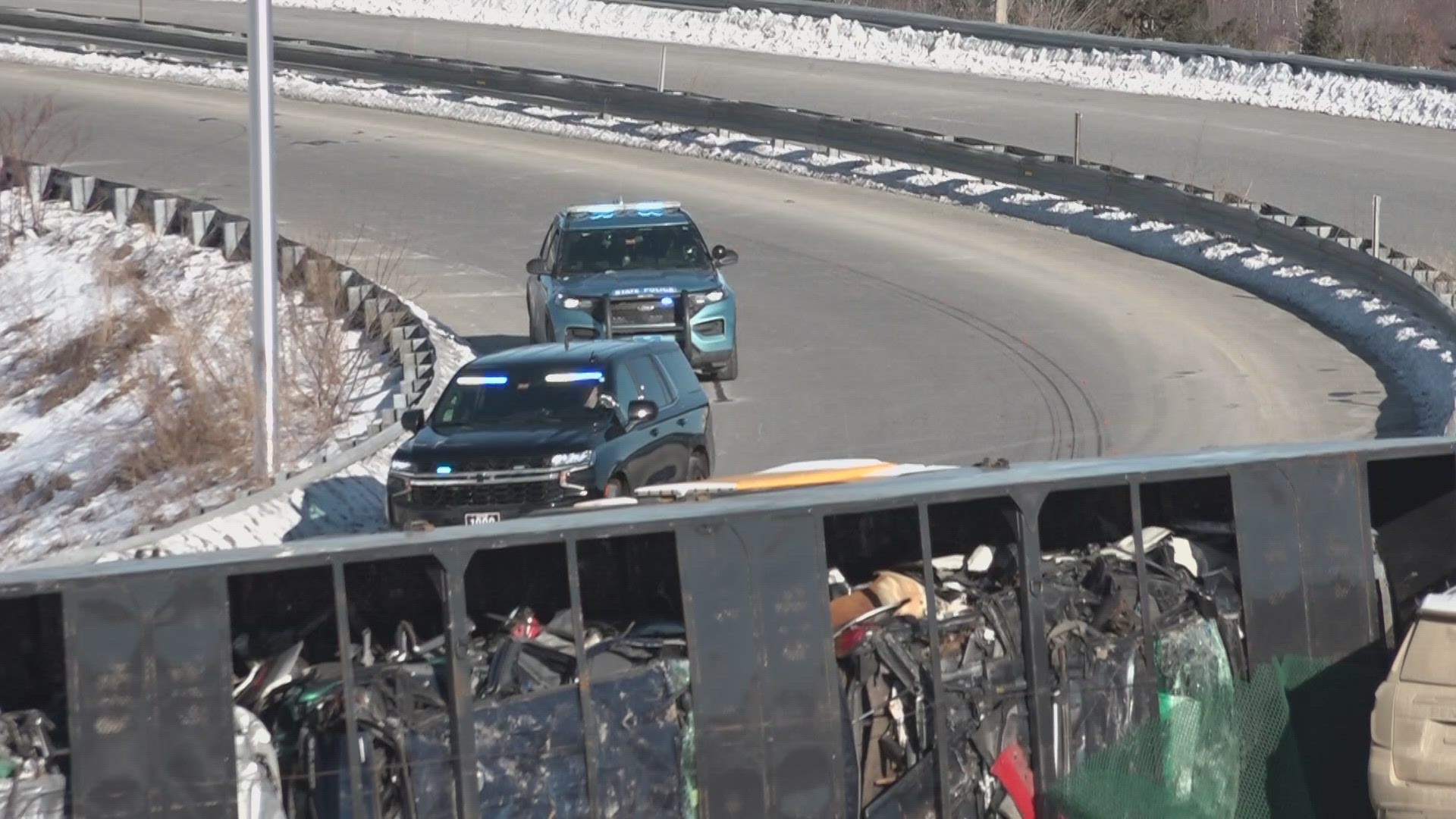 The tractor-trailer driver reportedly failed to negotiate the turn, causing it to roll over into a guardrail and strike a sheriff's deputy cruiser.