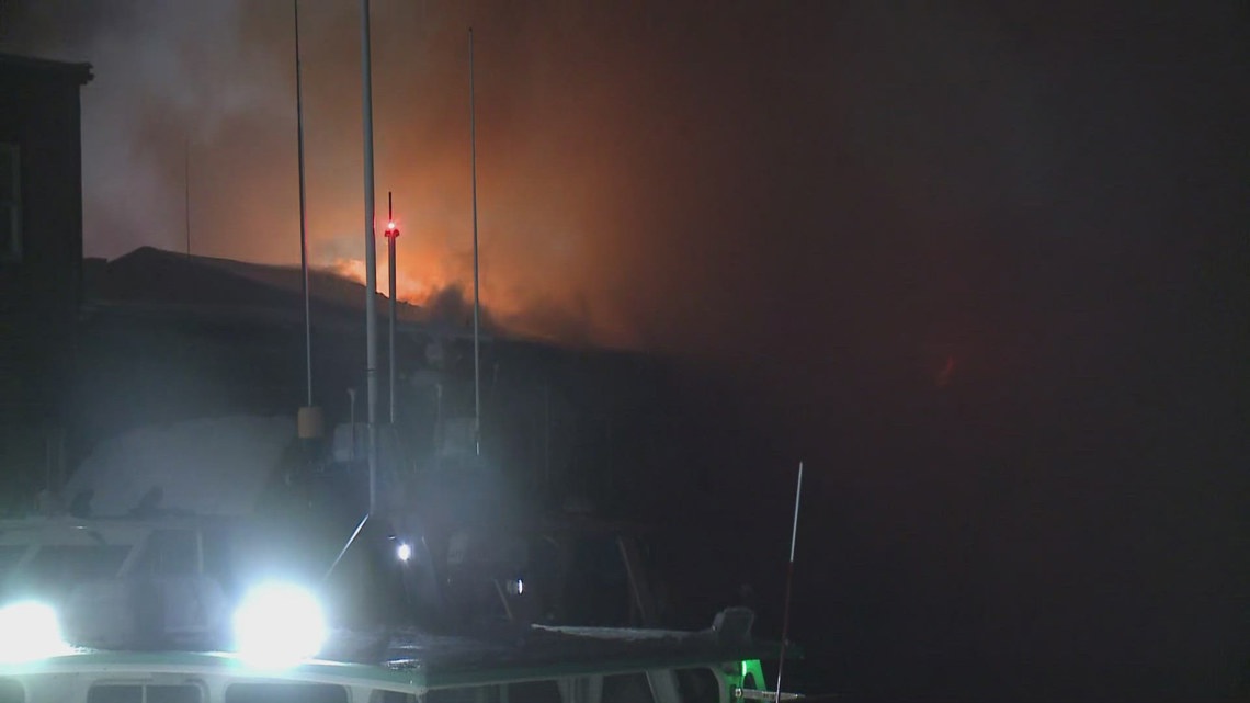 Loud bangs heard as crews continue to work to clear large fire on ...