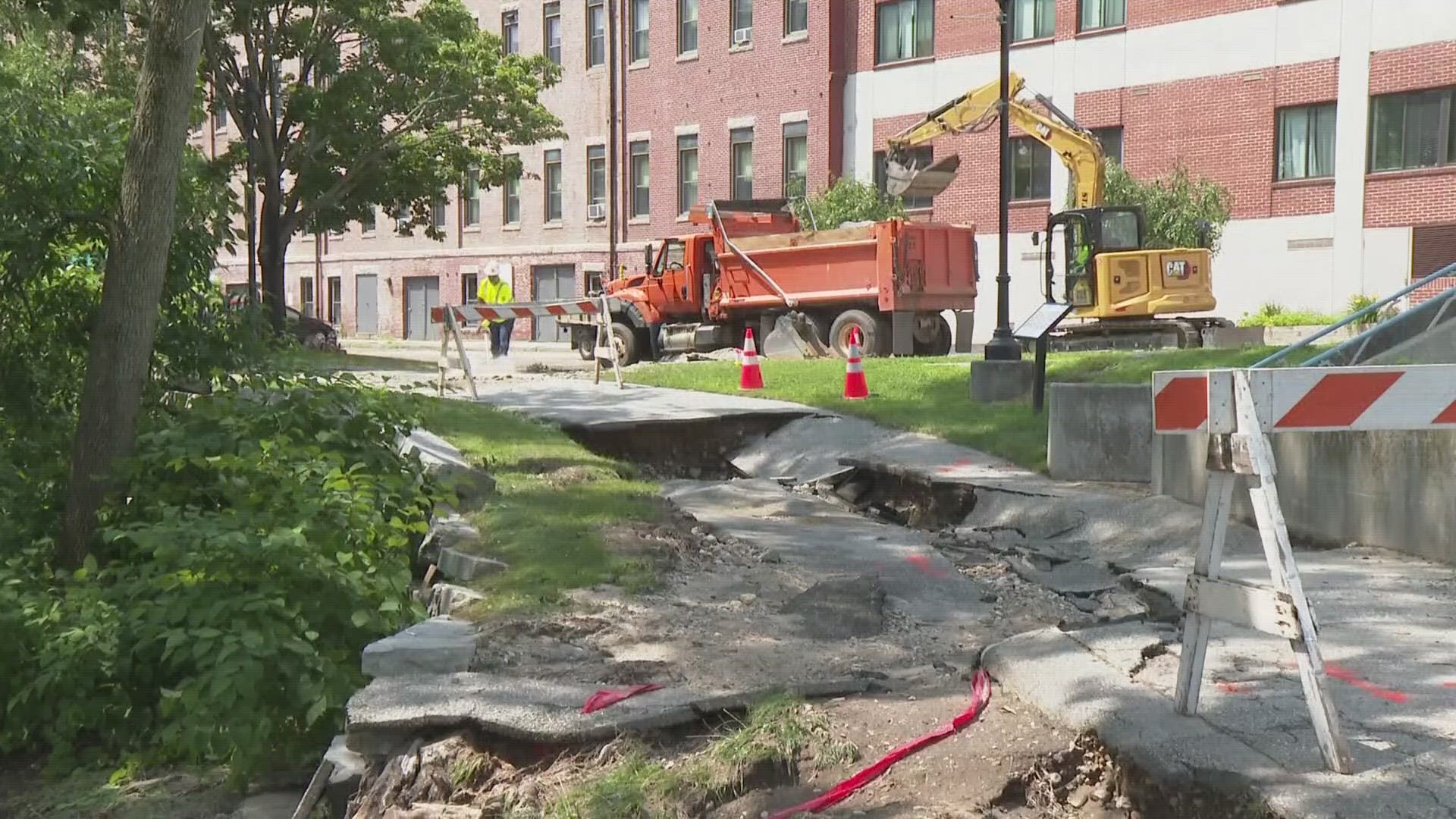 Dozens of people were forced out of their apartment building after water caved through the roof in Lewiston, while the City of Auburn forecasts millions in repairs.