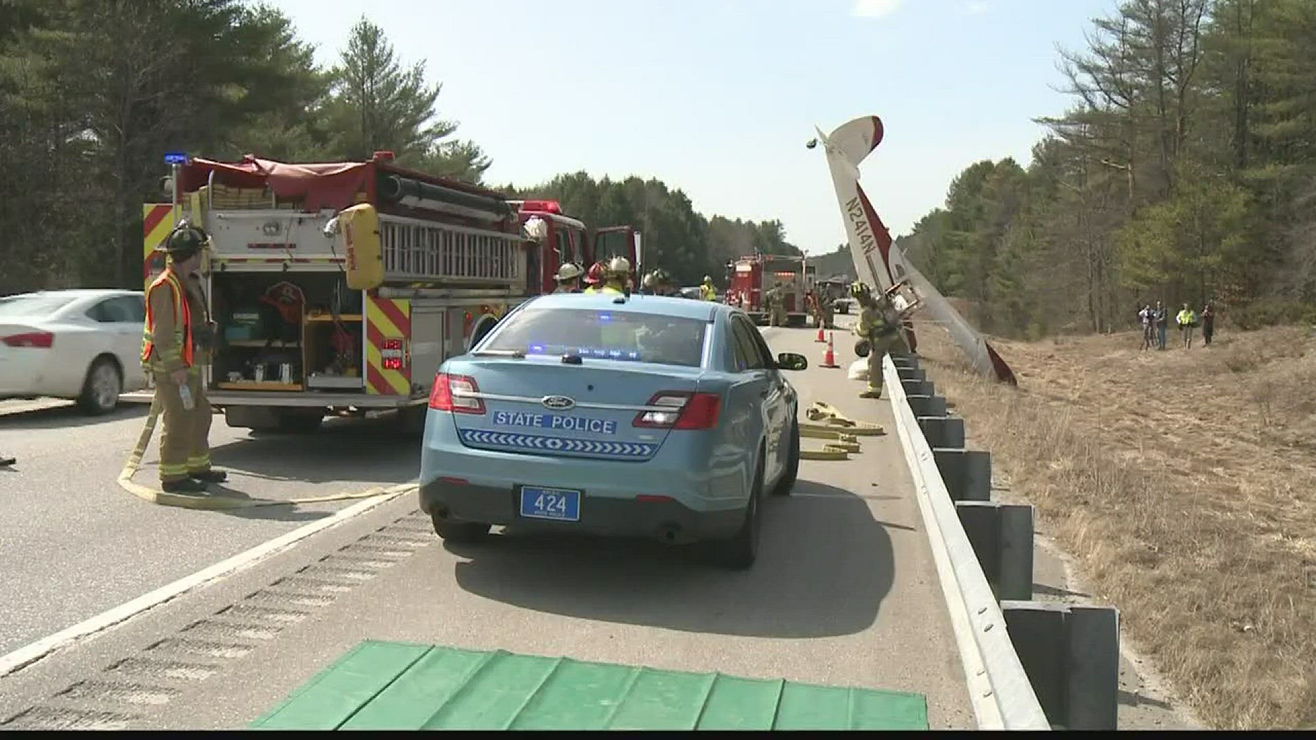 Plane crashes into guardrail on highway.