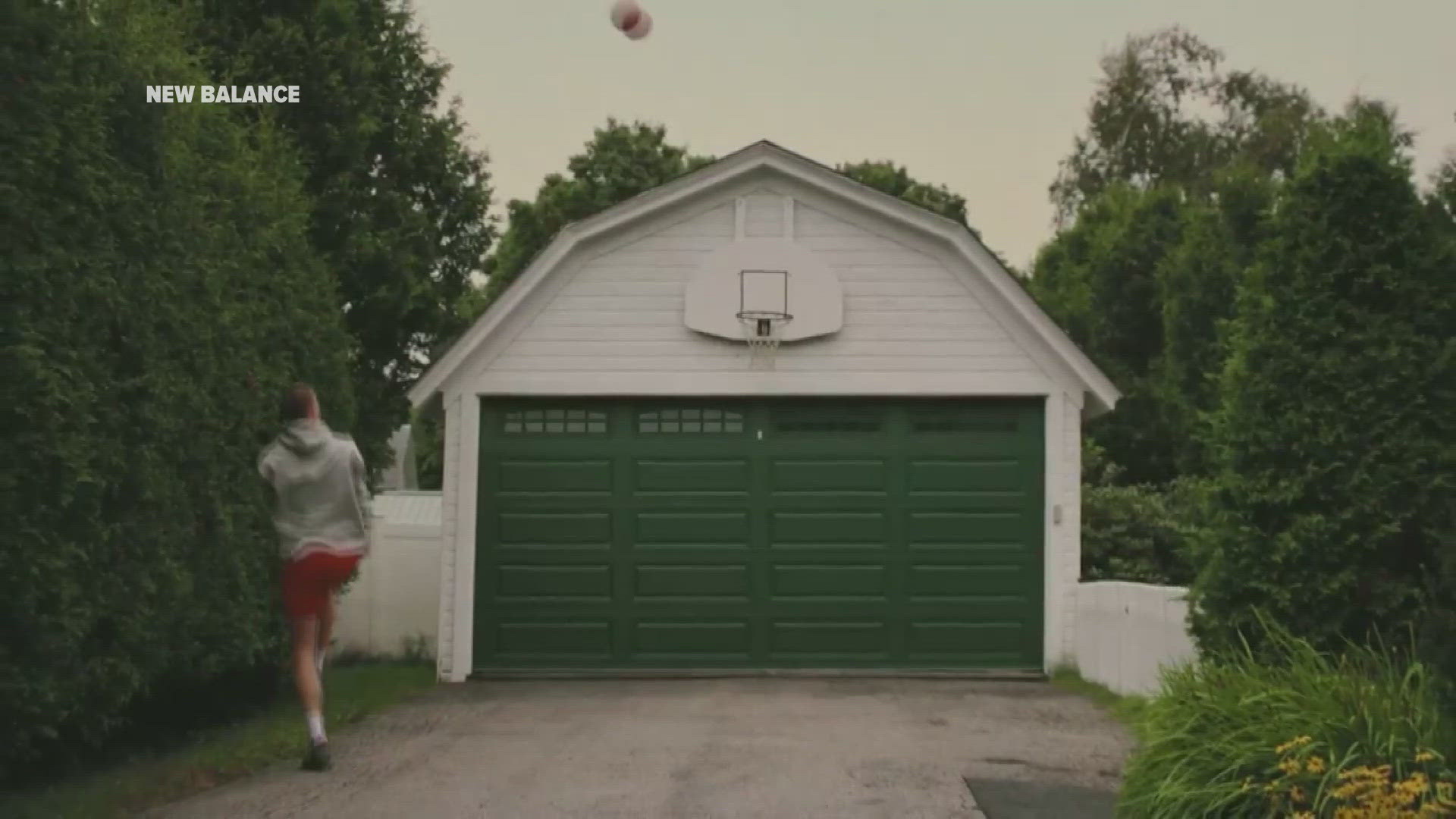 As part of Monday's announcement, New Balance posted a video depicting Flagg practicing his skills on a driveway basketball hoop in Newport.