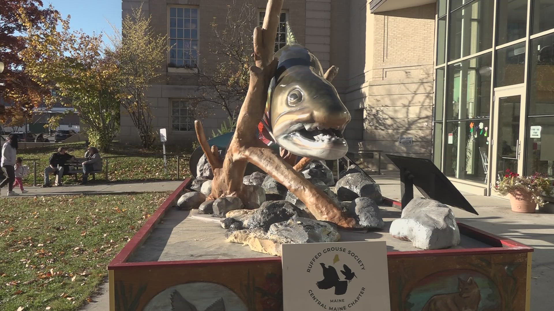 A 14-foot sculpture of Maine’s heritage fish, the sea-run brook trout, stands outside the Bangor Public Library.