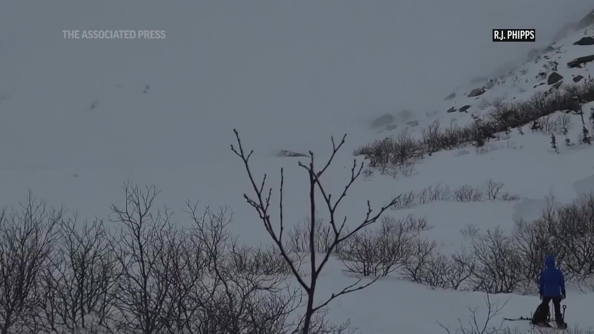 While a skier was able to scramble to the side of the avalanche, a snowboarder appeared to almost surf the avalanche down the mountain.