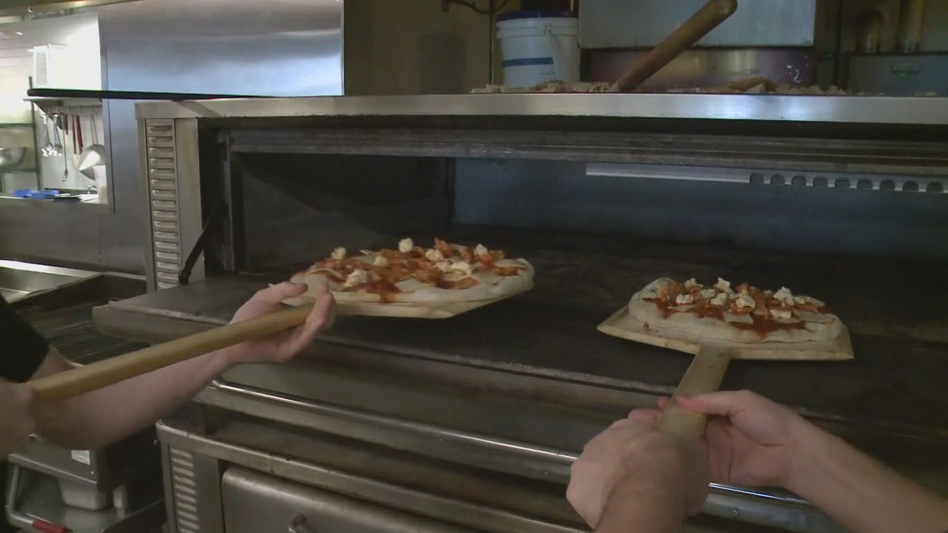 NEWS CENTER Maine's Aaron Myler learns how to make pizza at Monte's Find Foods in Portland.