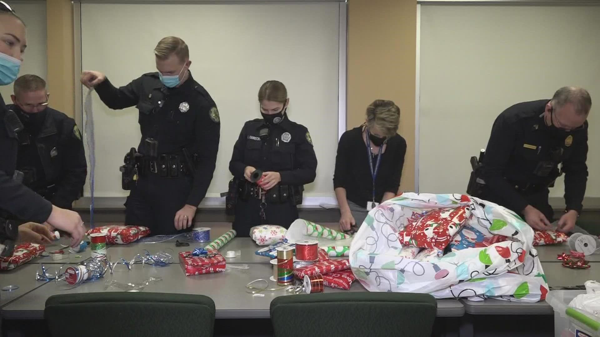 After shopping with the kids, Bangor police officers wrapped all the gifts and will be bringing them back to the lucky families on Thursday.