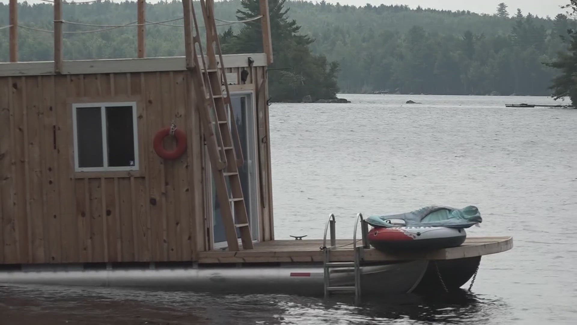 Jason Spinney anchors his houseboat yards from shore on Green Lake, a fact that has driven many property owners to push for a ban on overnight mooring.