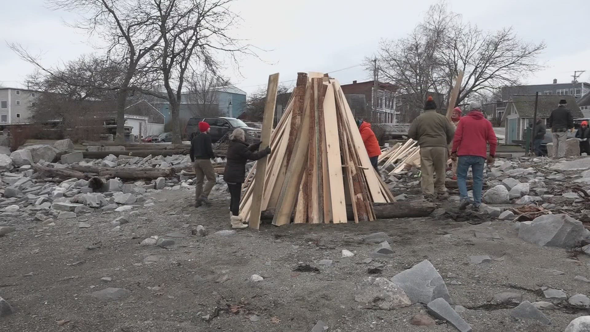 Volunteers in Belfast build beachside bonfire to light just before midnight as part of New Year's Eve tradition.