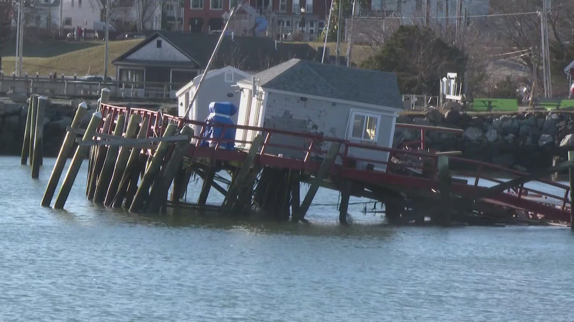 Wharfs remained toppled into the sea Thursday while residents cleaned up debris well into the day.