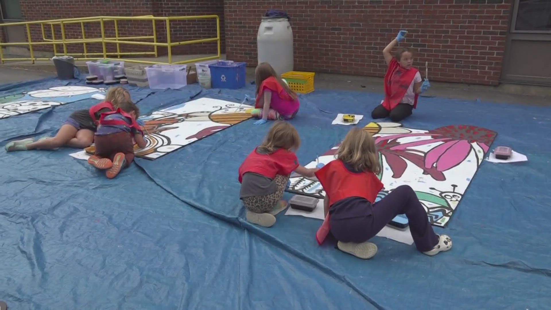 More than 150 students at Abraham Lincoln School are working with nonprofit Bangor Beautiful to paint a mural on the outside of the school.