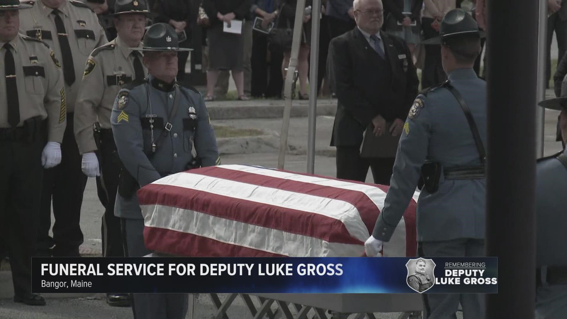 Maine State Police troopers took the American flag off Deputy Luke Gross' casket, folded it, and presented it to his family during his funeral service.