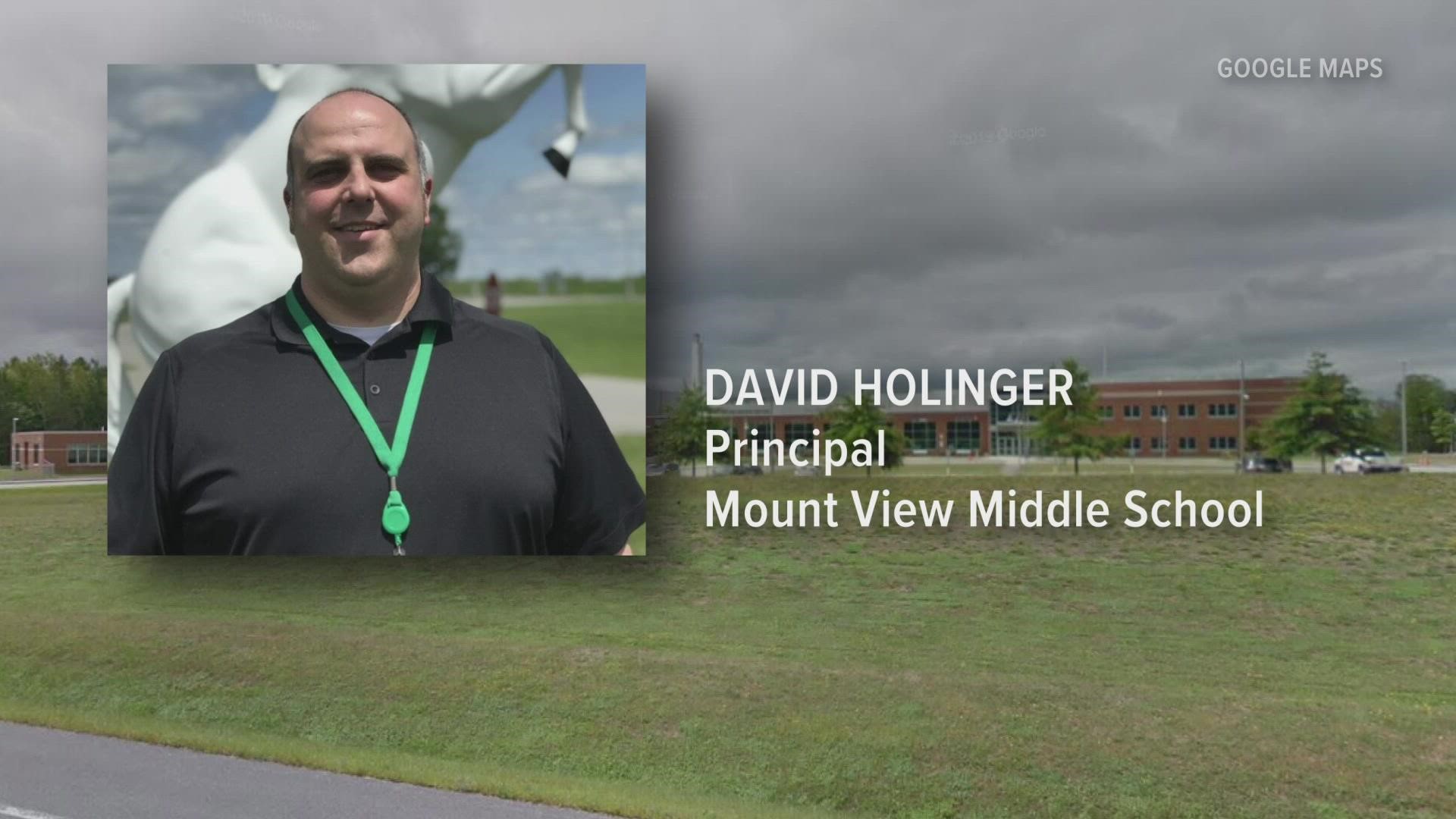 Police say David Holinger of Belgrade, principal of the Mount View Middle School, is facing three charges, and is expected to appear in court next month.