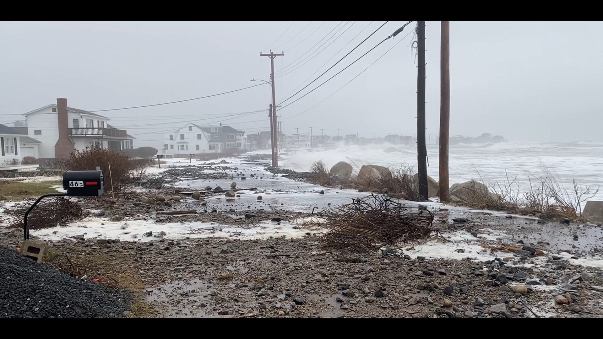 Debris covers roads in Wells as a record-setting storm impacts Maine on Saturday.