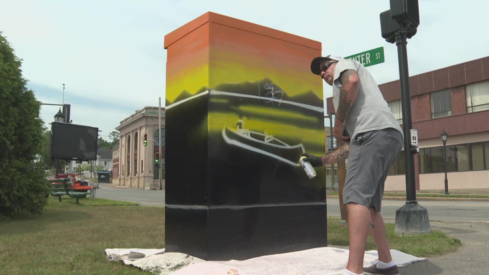 Two electrical boxes in Peace Pole Park get a colorful makeover.