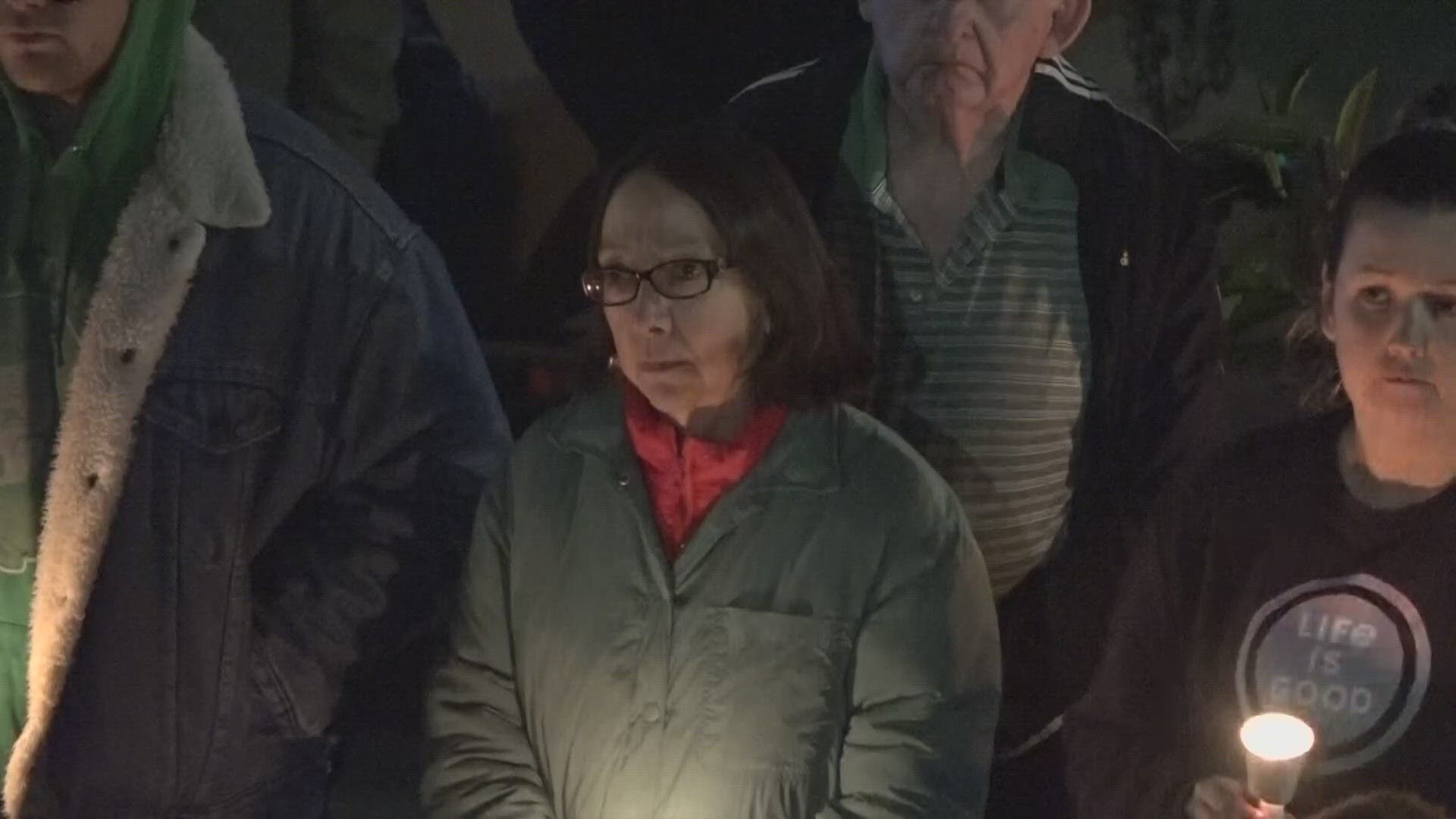 Grieving faces revealed themselves in candlelight in front of Bangor City Hall Sunday as dozens gathered for a vigil to honor the victims in the Lewiston shooting.