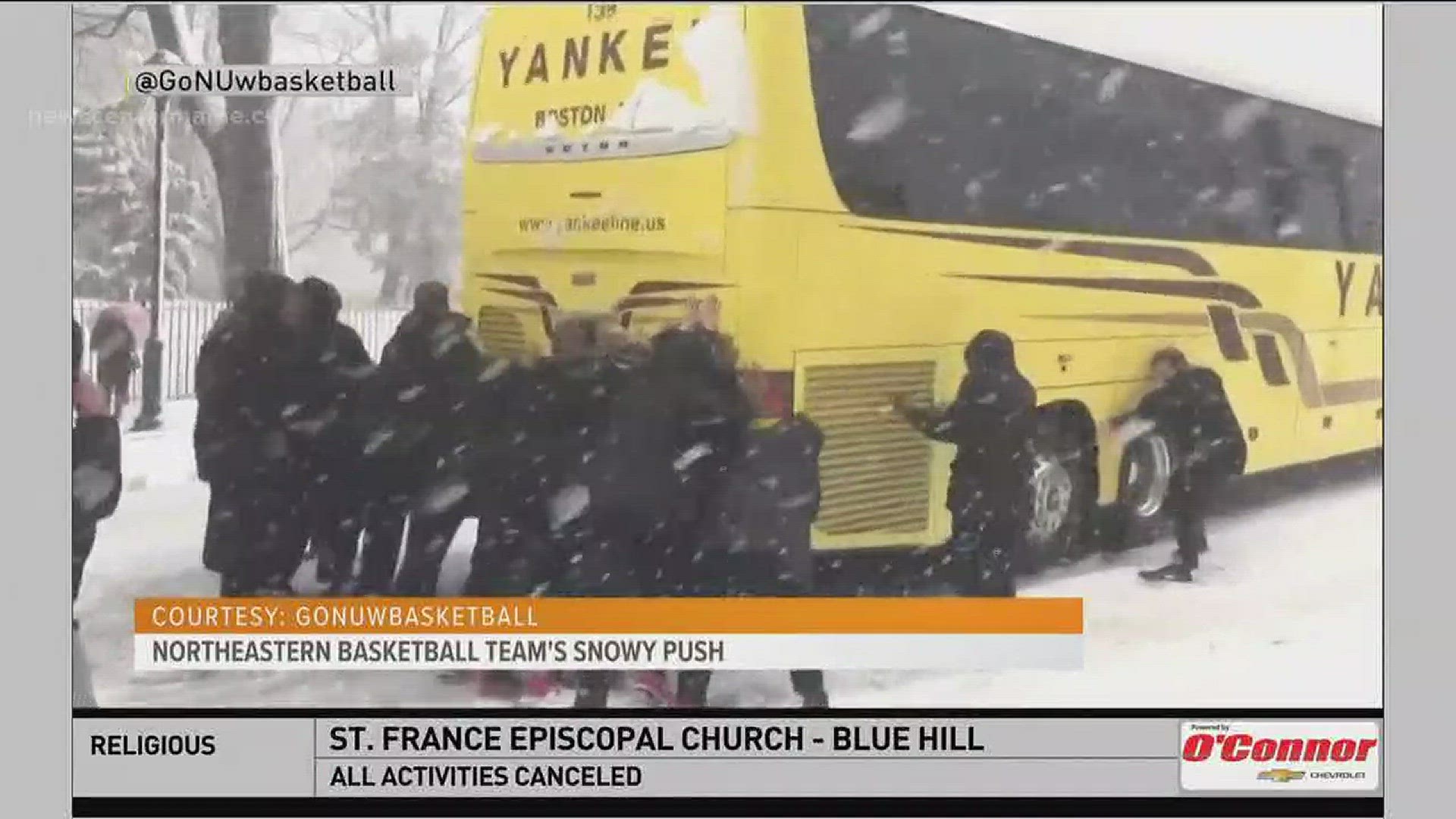 Women's basketball team from Northeastern pushes bus in the snow