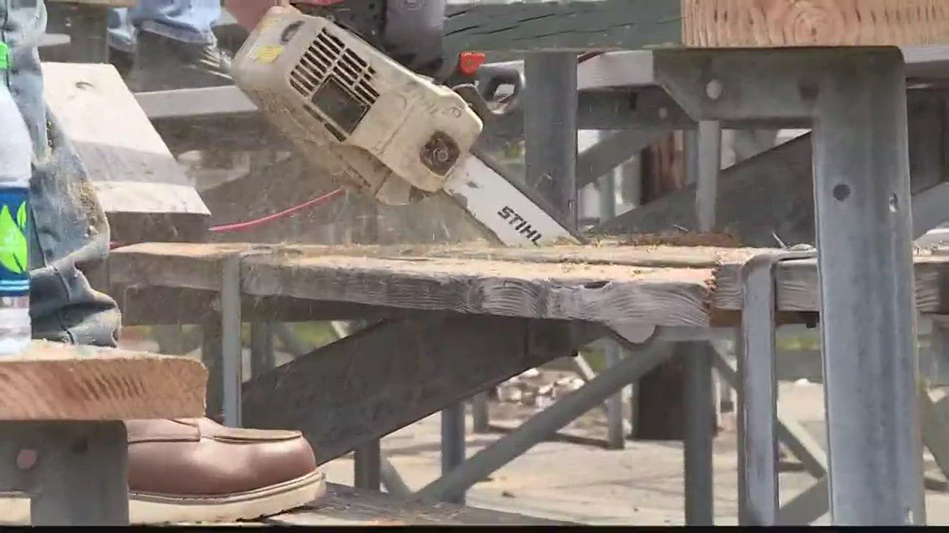 Volunteers help take down Waterhouse Field bleachers