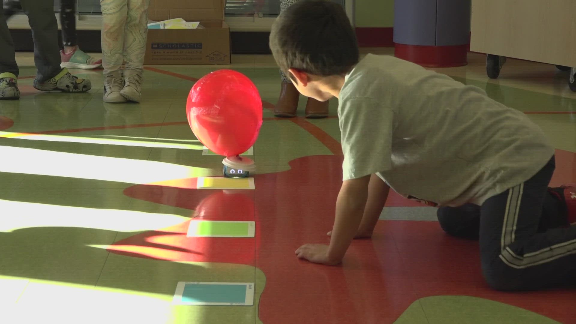 The "Balloons Over Broadway" project at Dyer Elementary School's library uses art and robotic cars to mimic the Macy's Thanksgiving Day Parade.