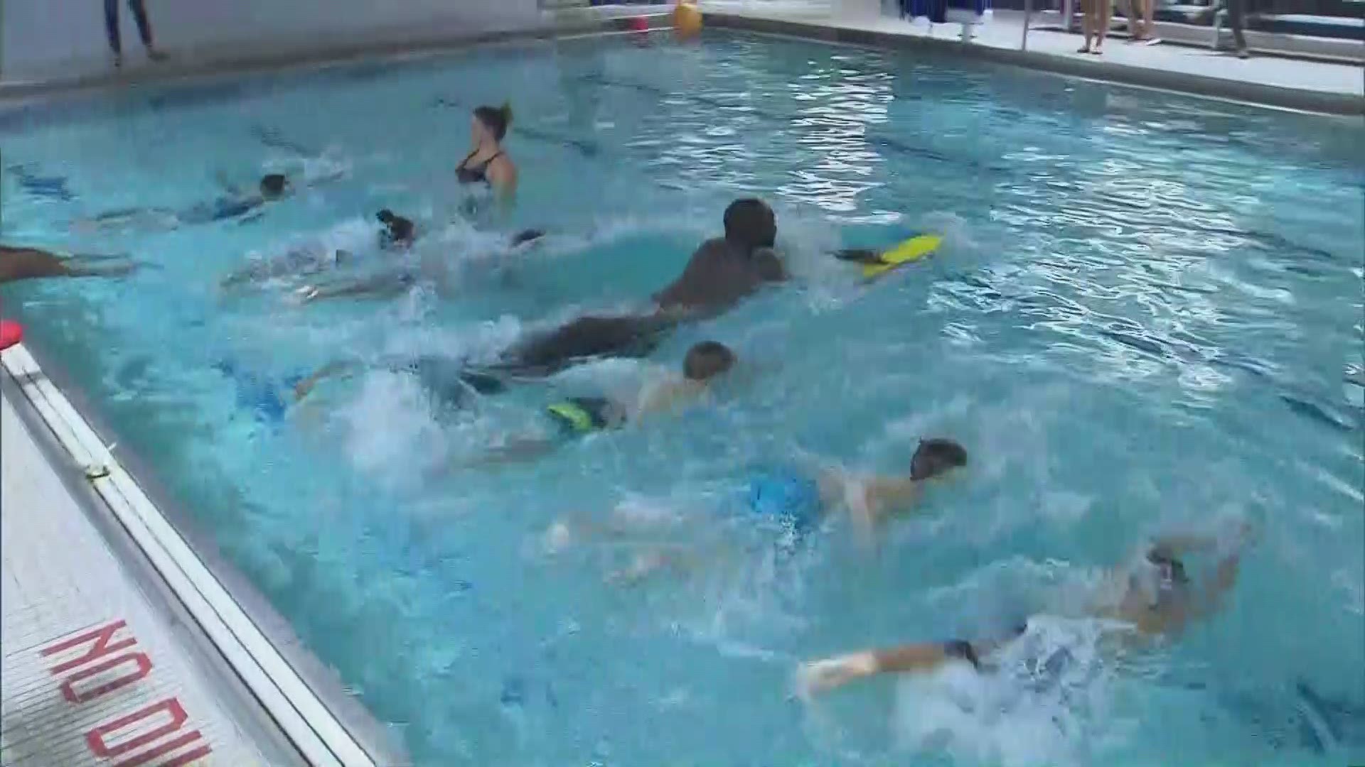 Celtics center Tacko Fall looks like a whale among guppies as he takes swimming lessons with a class of children.