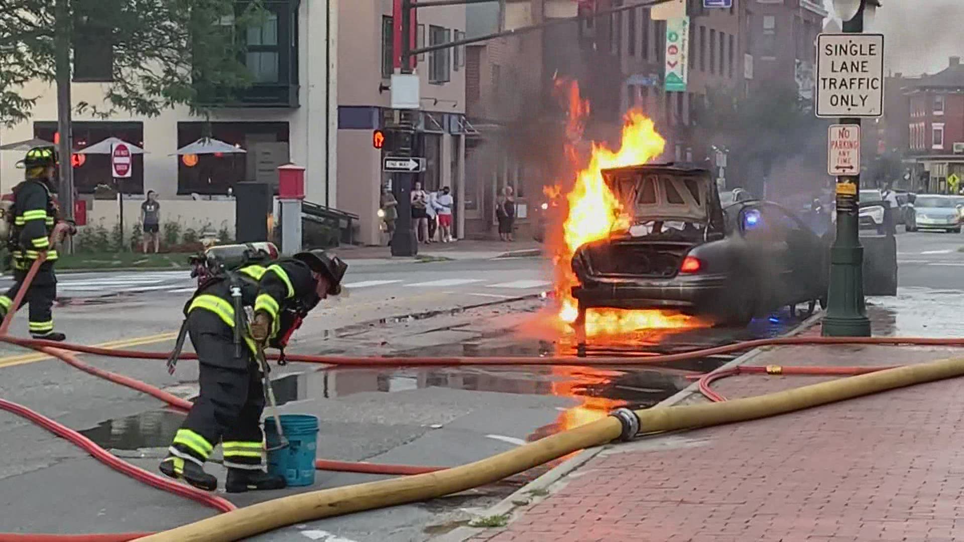 A car goes up in flames, moments after the occupants get out.