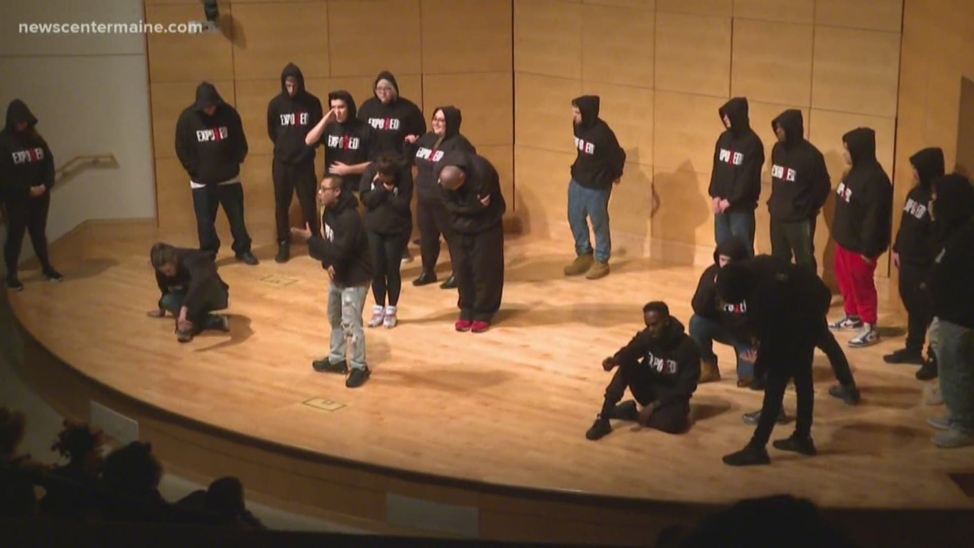 A group of people who share experiences in youth incarceration tell their stories on stage.