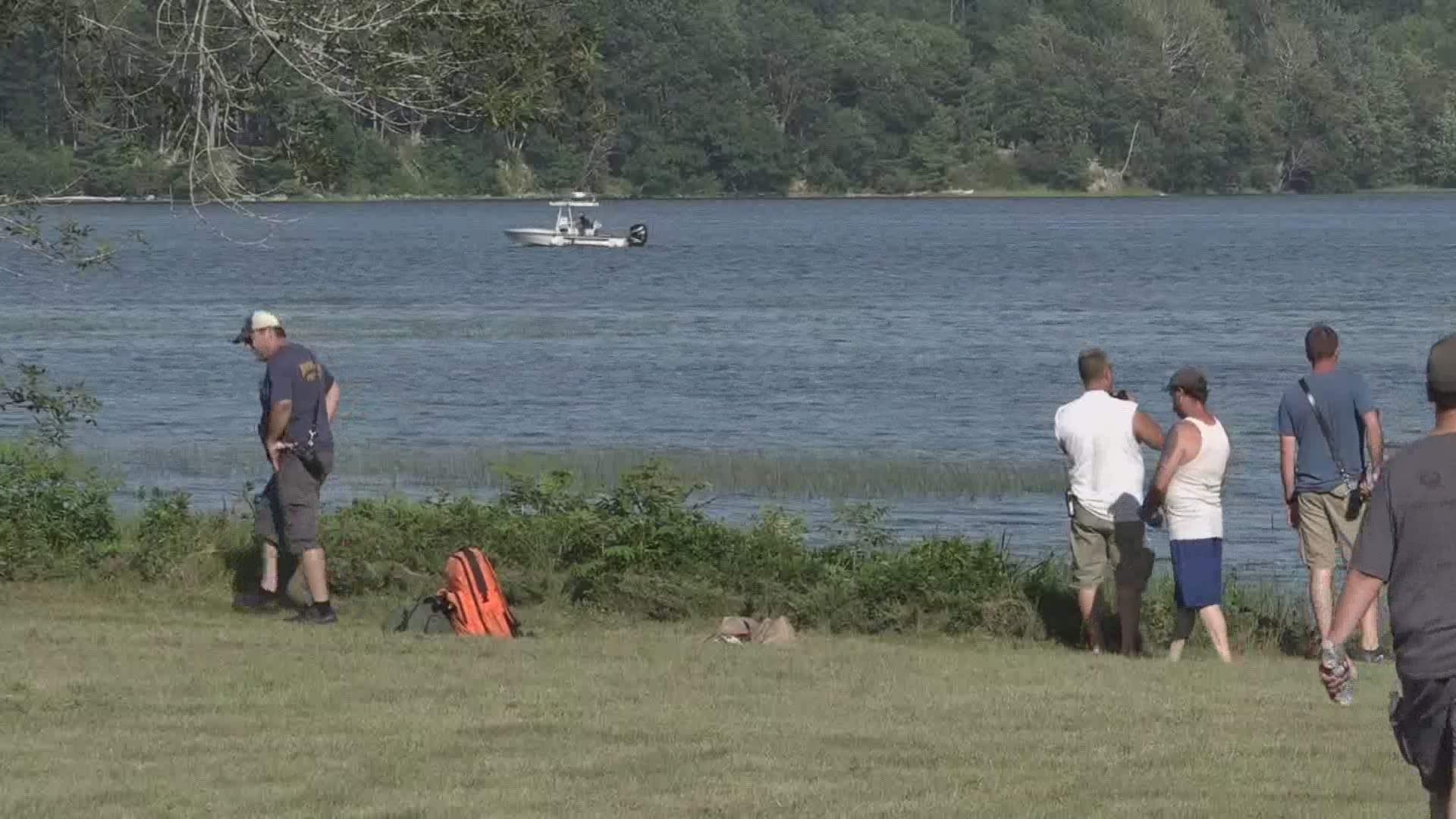 A man and woman went swimming off the back of their boat and officials say the man went underwater and never emerged.