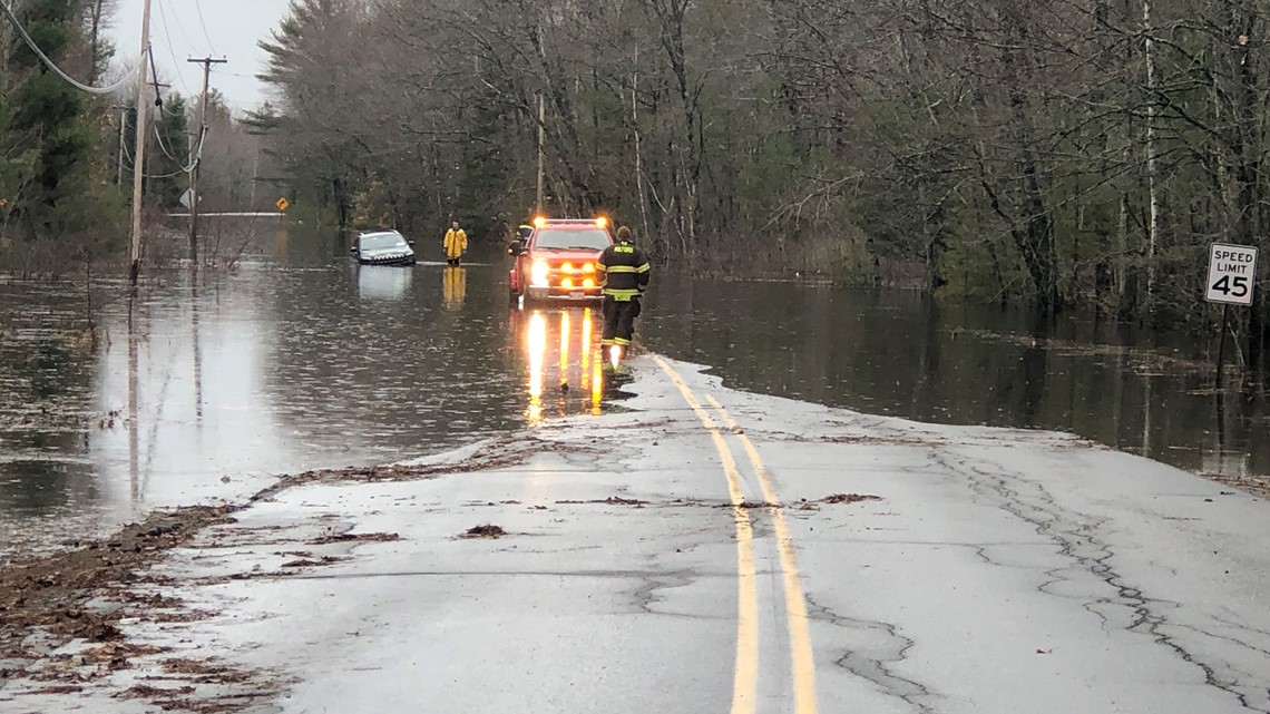 Man stranded on a flooded road in Milford