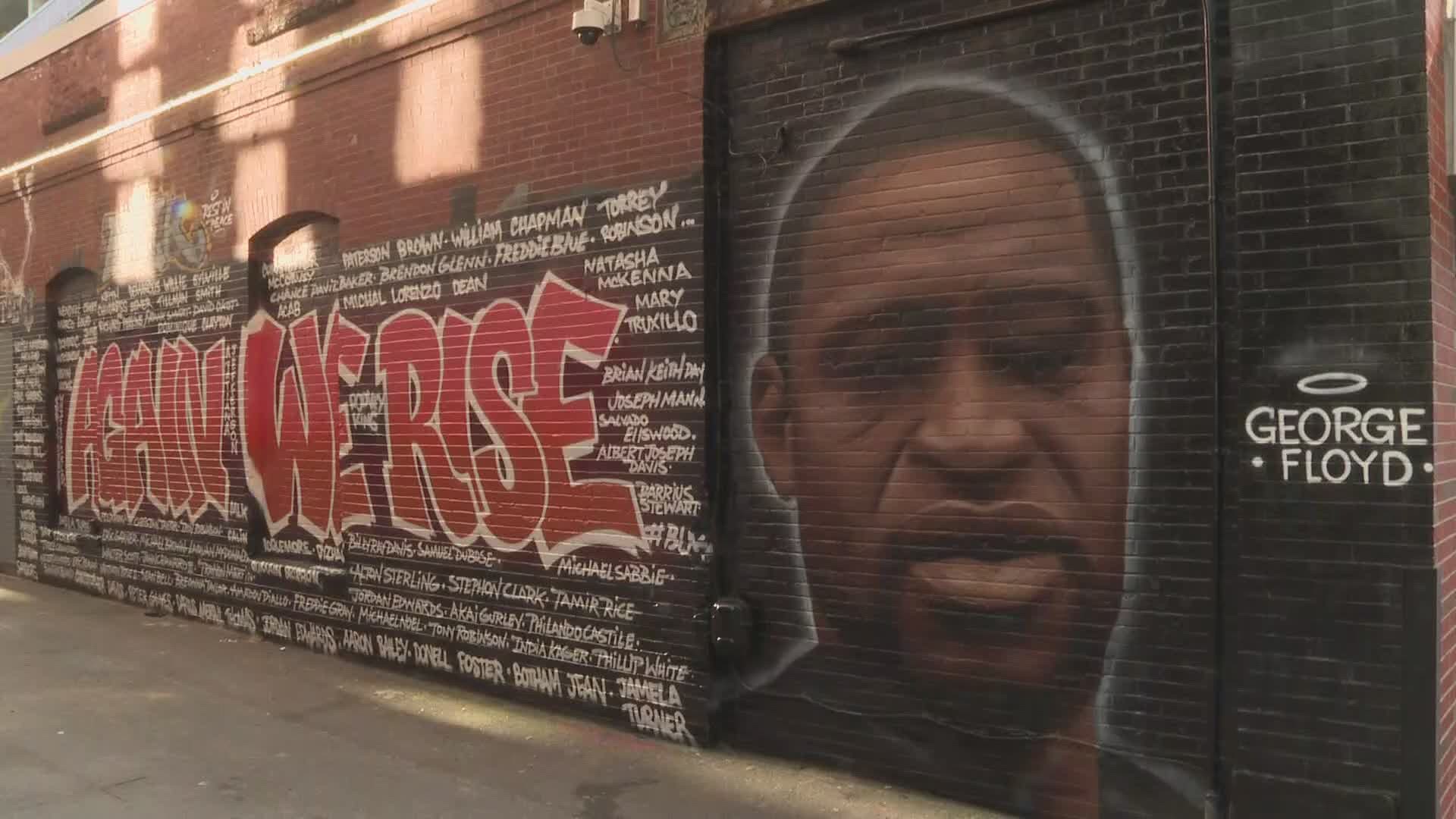 A mural was painted that honors George Flyod by three artists on a wall outside the nightclub, Aura on Center Street in Portland.