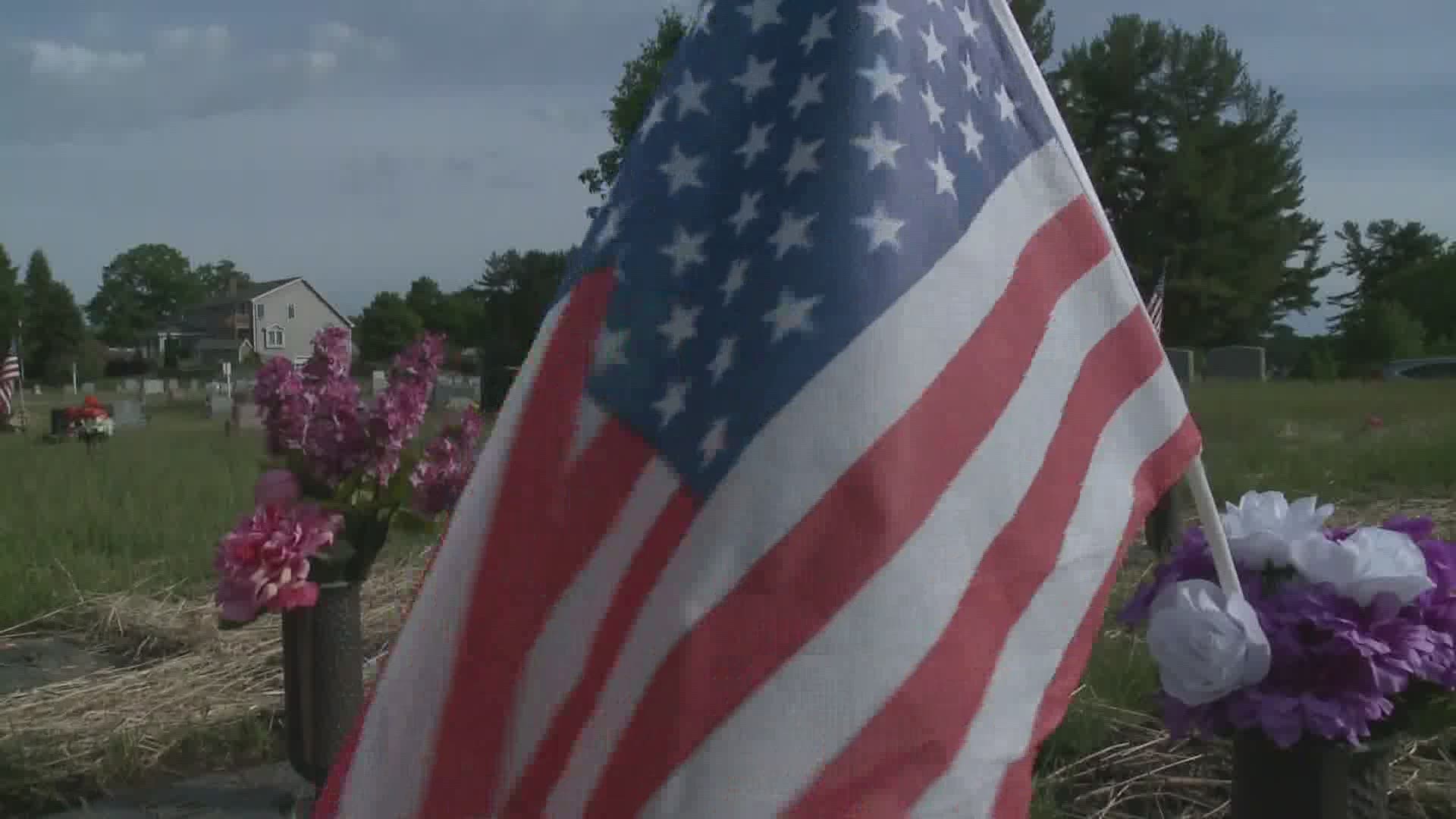 Rotary Club members placed an American Flag on the graves at Saint Joseph's Cemetery.  They also presented a check to "Honor Flight Maine" for $5 thousand dollars