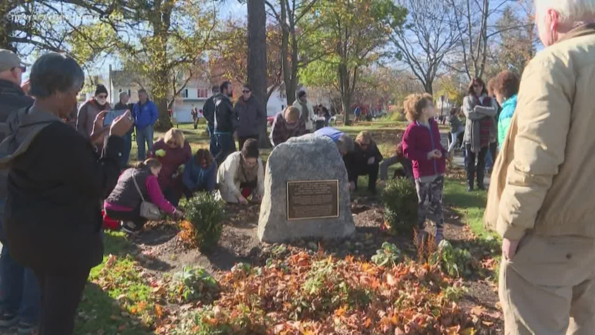 Dozens gathered to remember the victims at a permanent memorial at Longfellow park.
