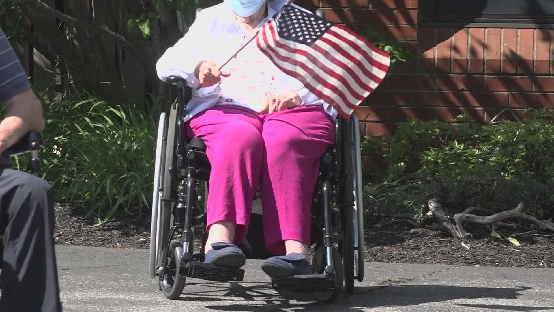 Dozens celebrated veterans with a parade of cars, waving flags, and cheering as they drove by the Maine Veterans Home in Scarborough.