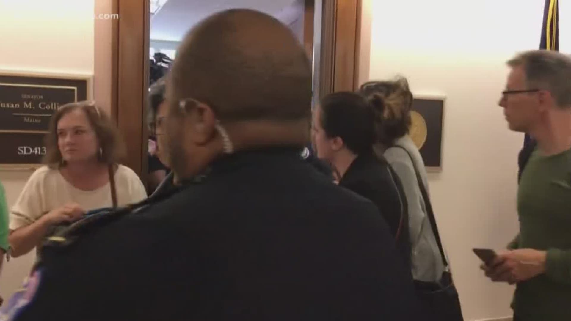 Demonstrators protest outside Collins' office in DC