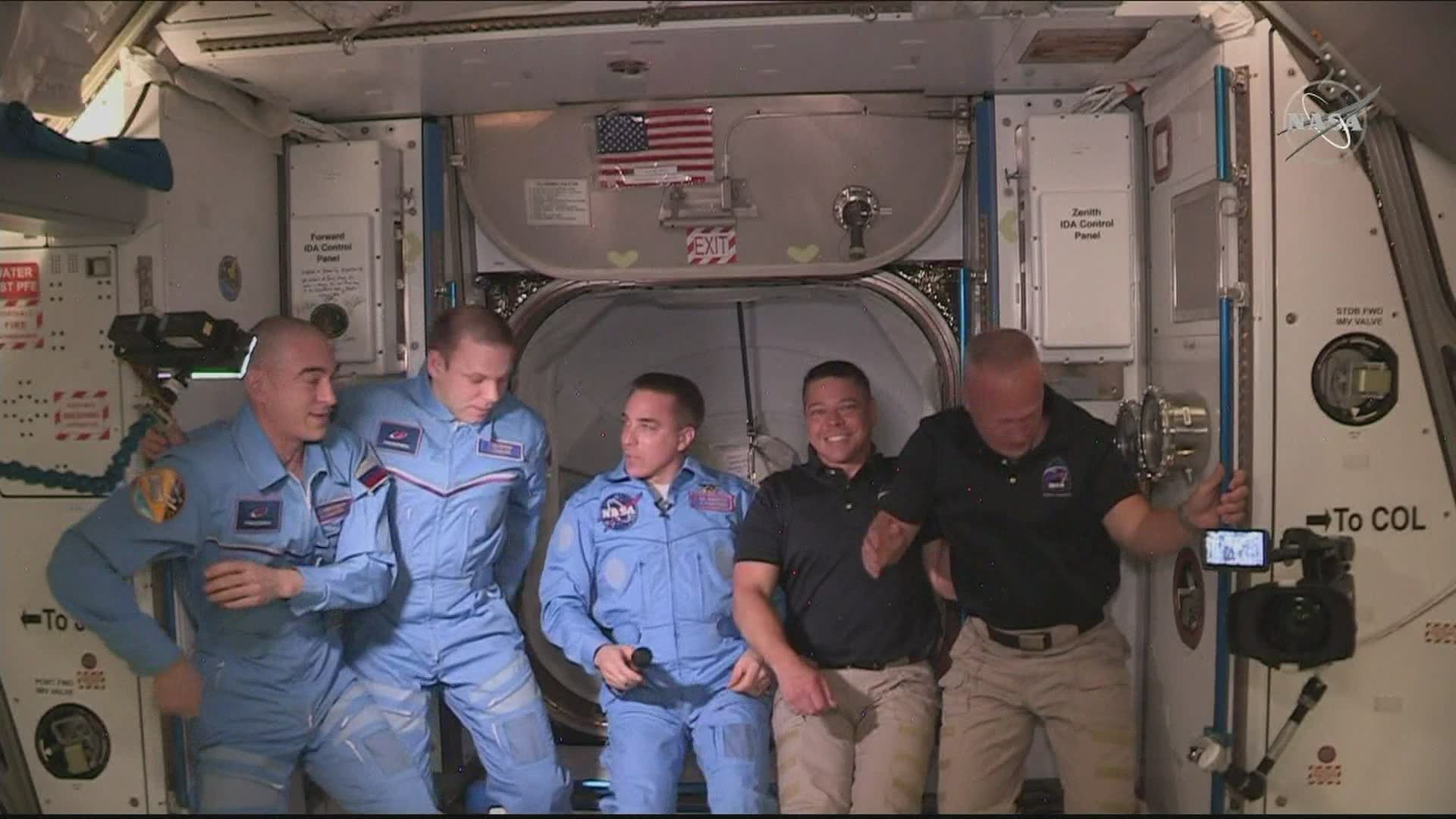 Two NASA astronauts and their SpaceX capsule docked at the international space station.