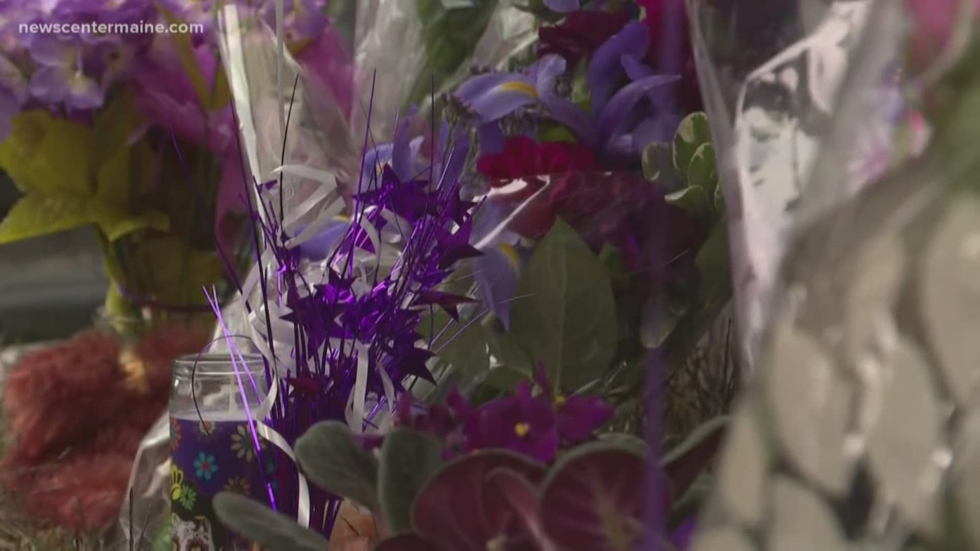 Family and friends held a vigil outside Melissa Sousa's home Friday morning, many bringing purple flowers to raise awareness about domestic violence.