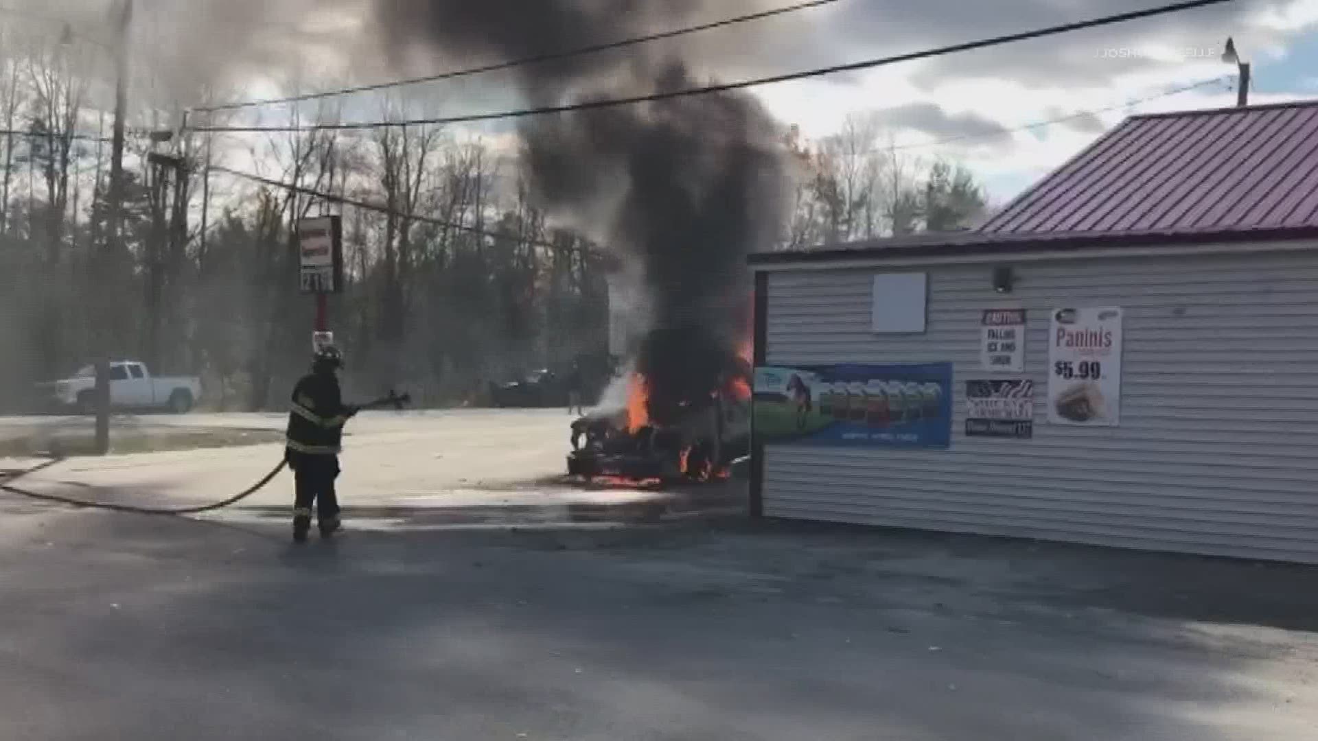 A pick-up truck on fire parked between gas pumps in Greenbush.